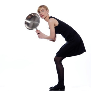 woman holding a frying pan